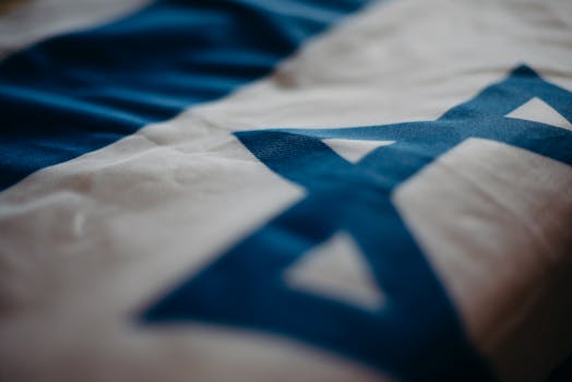 pexels-photo-4033852-4033852 Detail of the Israeli national flag highlighting the Star of David, emphasizing its cultural significance.